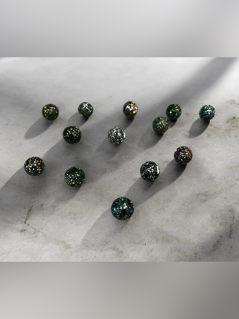 13 "galaxy" or "stardust" vintage glass peewee marbles.